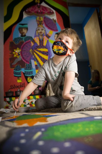 Garfield Elementary kindergartner Lincoln Vaneenoo paints on the floor of the new Spokane artists collective Make a Difference Co. Lab Studios, or M.A.D., at 3038 E. Trent Ave., on Thursday.  (Libby Kamrowski/The Spokesman-Review)
