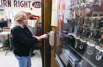 
Spokane Valley Museum curator Jayne Singleton dials a rotary phone that is part of an exhibit at the museum that features central office step switches. The Spokane Valley Museum will participate in the 