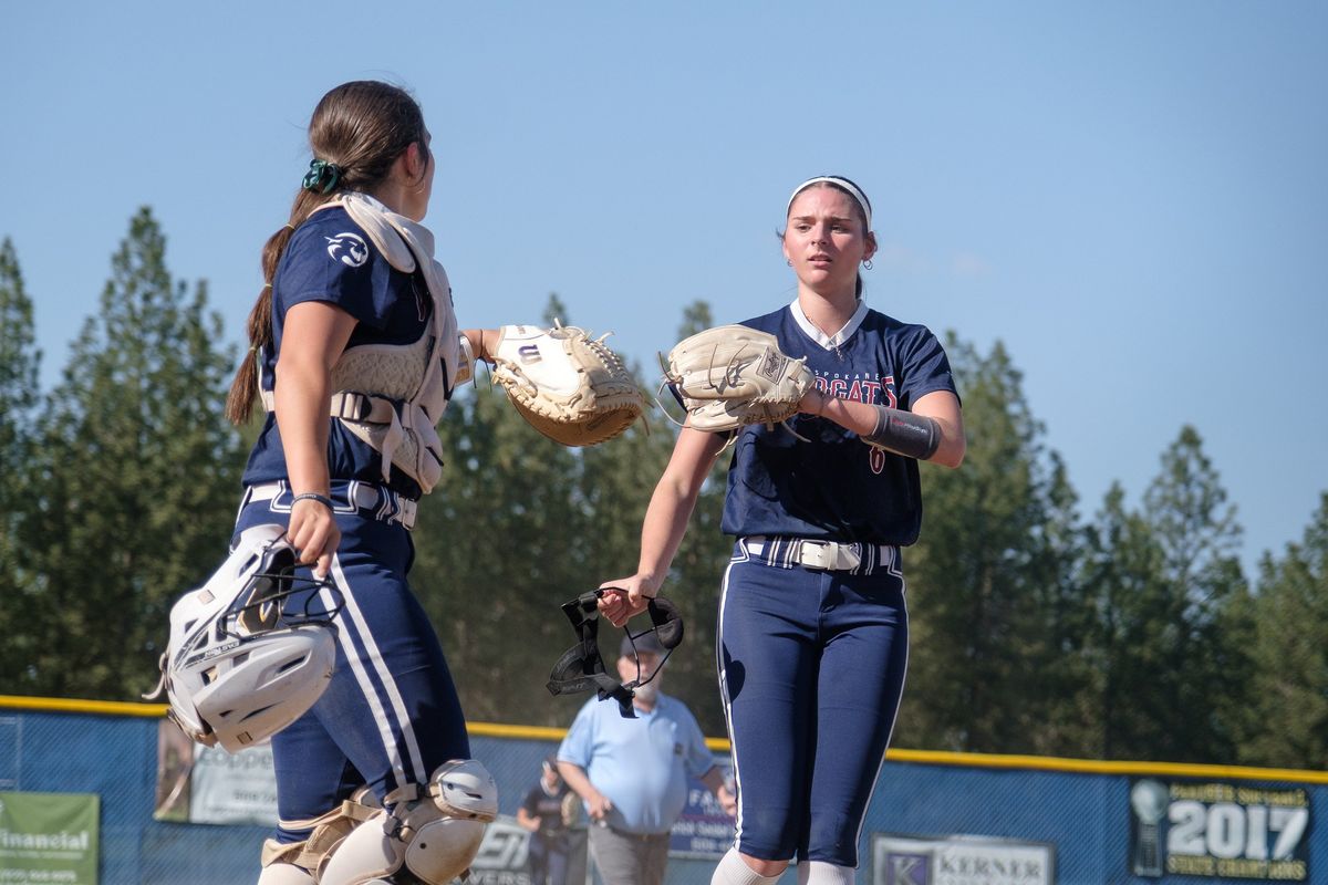 Mt. Spokane pitcher Addison Jay, right, taps gloves with catcher Quincy Schuerman during a GSL game against Mead on Thursday at Mead High School.  (Madison McCord/For The Spokesman-Review)