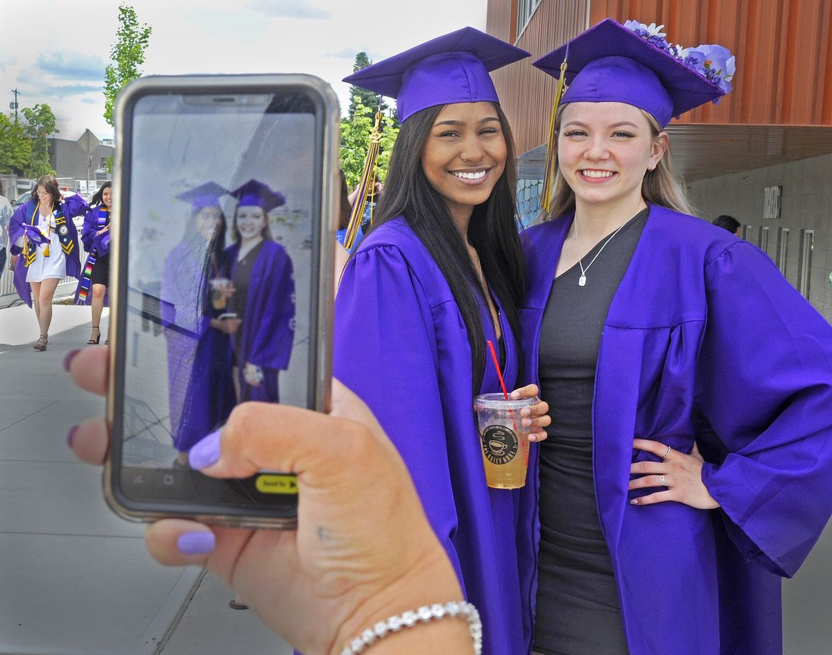 Rogers High School graduates and best friends Jalayla Brown (left) and Sydney Vining pause for a photo by Dawn Phillips Sunday, June 12, 2022, outside the Podium in Spokane, Wash. Phillips is the mother of Jalaya, and she notes that for the next year there will be no books, exams or school for her daughter.   (Christopher Anderson/For The Spokesman-Review)
