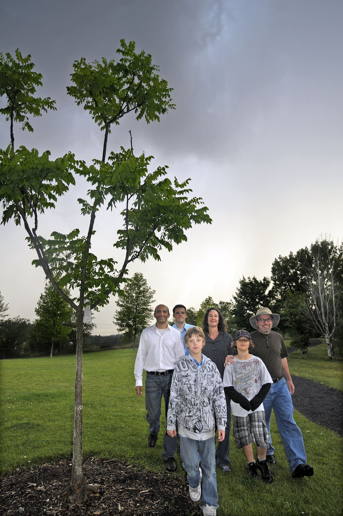 A group of Spokane residents walk past a “peace tree” planted in Polly Judd Park by Iranian bike tourists last year. The group reciprocated by traveling to Iran to plant peace trees in that country. From left, Shahrokh Nikfar, Jon Snyder, Jackson Snyder, Pam Deutschman, Zak Deutschman and Tom Deutschman. (CHRISTOPHER ANDERSON / The Spokesman-Review)