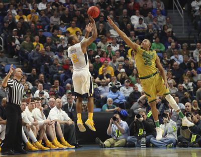 West Virginia guard Jevon Carter (2) makes a three-point shot against Notre Dame forward Bonzie Colson (35) late in the second half of a second-round men’s college basketball game in the NCAA Tournament, Saturday, March 18, 2017, in Buffalo, N.Y. West Virginia won, 83-71. (Bill Wippert / Associated Press)