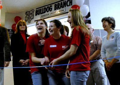 
Sandpoint High School students from left, Jarae Nordgaarden, Liara Nosiglia and Kourtney Smith cut the ribbon for the Bulldog Branch of the Horizon Credit Union located in Sandpoint High School. The three student have been trained as bank tellers. 
 (Kathy Plonka / The Spokesman-Review)