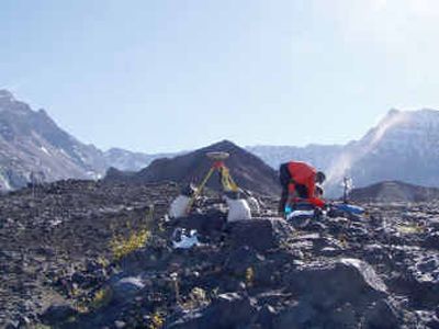 
Scientists with the U.S. Geological Survey install a GPS unit at Mount St. Helen's on Monday. 
 (Associated Press / The Spokesman-Review)