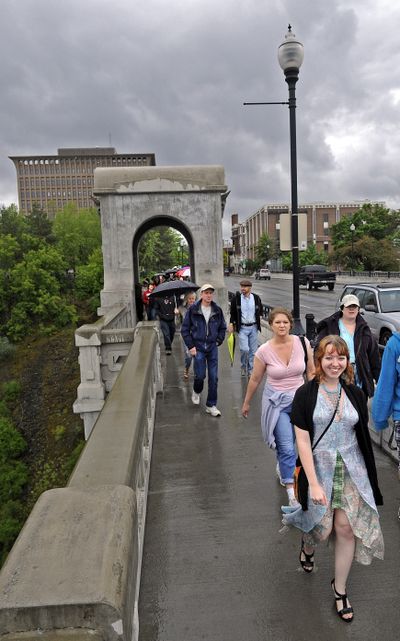 Taylor Malone, front right, organizer and leader of Spokane’s SlutWalk, walks across the Monroe Street Bridge to the county courthouse with other participants on Saturday. (Christopher Anderson)