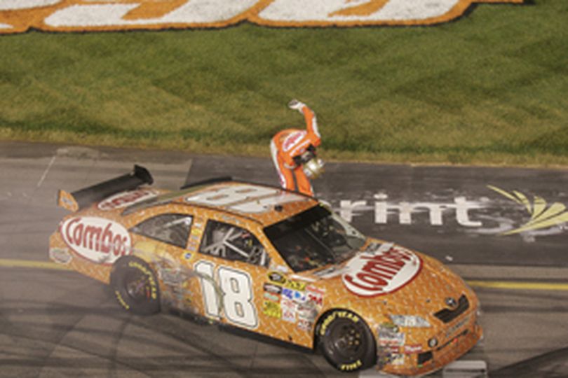 Kyle Busch does his trademark bow after winning the CROWN ROYAL presents The Russ Friedman 400 at Richmond International Raceway. The win came on Busch's 24th birthday and completed the weekend sweep at Richmond. (Photo Credit: Jason Smith/Getty Images) (Jason Smith / The Spokesman-Review)