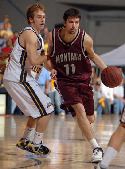 
Montana's Matt Dlouhy  moves past NAU's Josh Wilson. 
 (Associated Press / The Spokesman-Review)