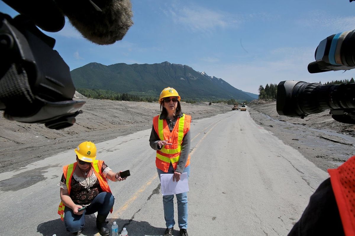 Lorena Eng, WSDOT Northwest Region administrator, speaks to the media Friday as road crews work to finish repair work on Highway 530 in Oso, Wash., which was buried in mud by a March 22 mudslide. The road will reopen today at noon. (Associated Press)
