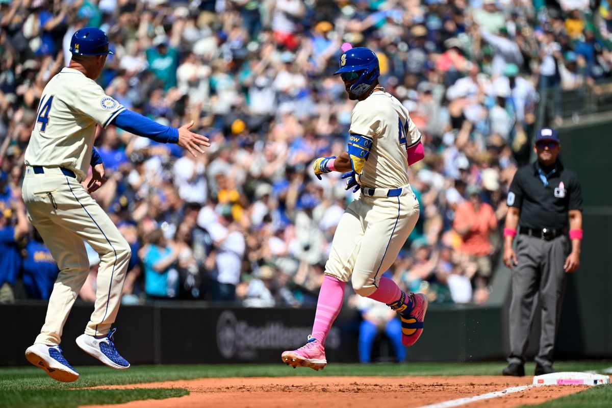 Mariners outfielder Julio Rodriguez rounds third base after hitting a home run against the A’s on Sunday at T-Mobile Park in Seattle.  (Getty Images)