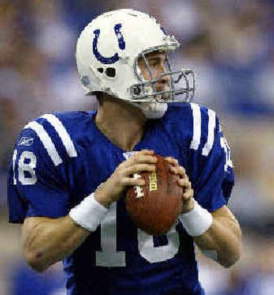 
Indianapolis Colts quarterback Peyton Manning was cool in the pocket Sunday, tossing five TDs against Houston.
 (Associated Press / The Spokesman-Review)