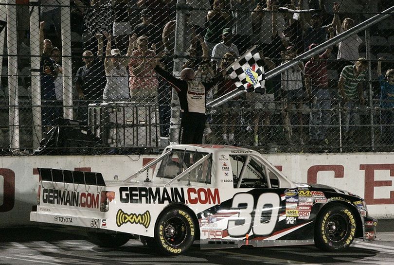 Todd Bodine, driver of the No. 30 Germain.com Toyota, waves the checkered flag after winning the NASCAR Camping World Truck Series Too Tough To Tame 200 at Darlington Raceway Saturday in Darlington, S.C. (Photo courtesy Mary Ann Chastain/Getty Images for NASCAR) (Mary Chastain / Getty Images North America)