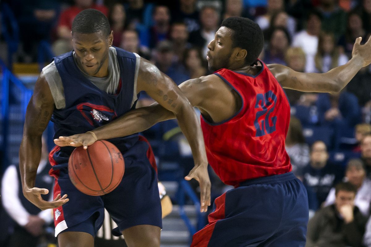 Gary Bell Jr., left and Gerard Coleman battle for control of the ball. (Colin Mulvany)