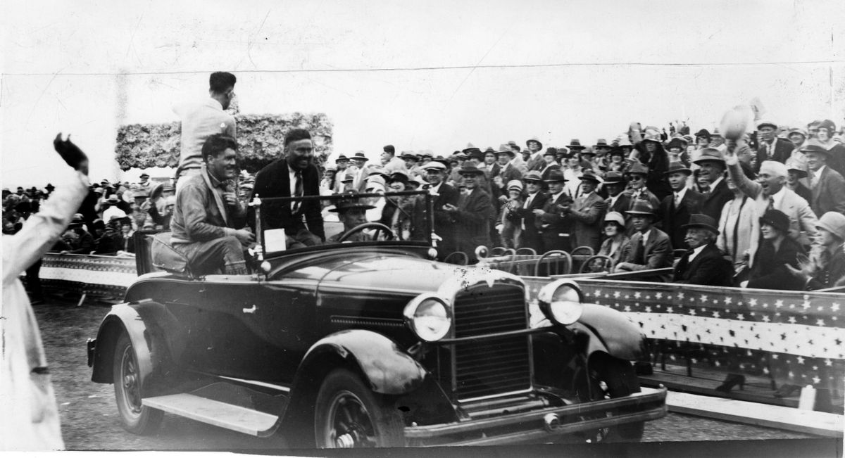 Winner Charles “Speed” Holman and third place-finisher Nick Mamer greet the cheering spectators at the finish of the 1927 National Air Race at Felts Field in Spokane.