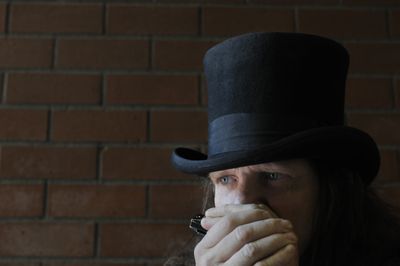 Harmonica player Rick Bocook, known for his black hat and meandering melody, plays on his usual corner near Macy’s in downtown Spokane recently. (Jesse Tinsley / The Spokesman-Review)