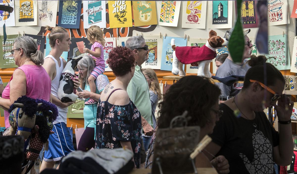 Visitors to the Garland Street Fair crowd the roads as they view merchant’s wares, Aug. 12, 2017, in Spokane.  (DAN PELLE)
