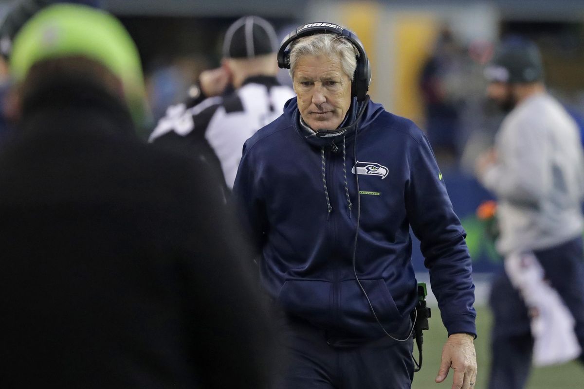 Seattle Seahawks head coach Pete Carroll walks on the sideline during the second half of an NFL  game against the Arizona Cardinals on Dec. 31, 2017, in Seattle. (Elaine Thompson / AP)