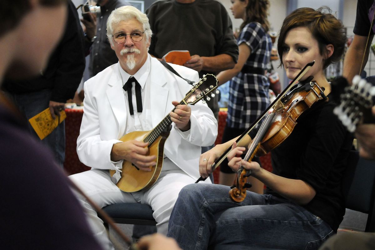 Carlos Alden, of Spokane, plays his mandolin, and Nicole Nielsen, of Coeur d’Alene, plays her fiddle during a jam session in the common area of the  Spokane Community College Lair during the Spokane Folklore Society Fall Folk Festival on Saturday. (Dan Pelle / The Spokesman-Review)