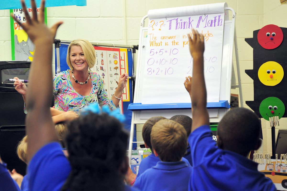 Teacher Deanna Jump quizzes her first-grade students at Central Fellowship Christian Academy in Macon, Ga., on Wednesday, Sept. 12, 1012.  Jump is the first million-dollar seller on teacherspayteachers.com, a website that teachers use to buy and sell school supplies, bulletin board designs and lesson plans. (Todd Stone / Associated Press)