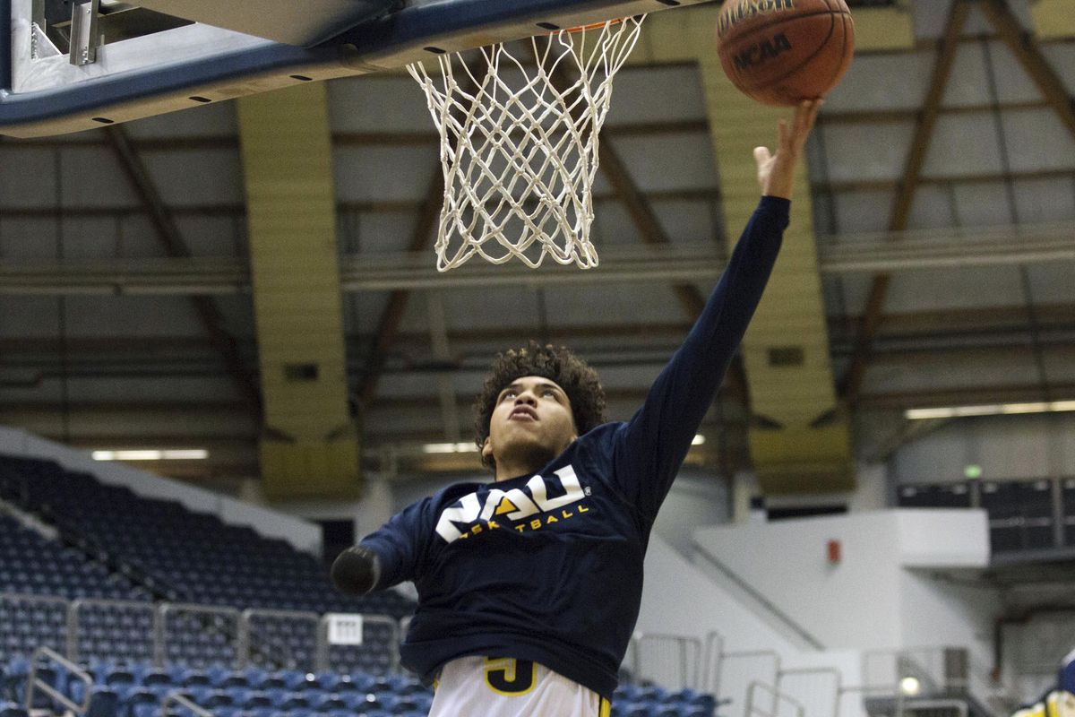 In this Jan. 18, 2018 photo, Northern Arizona’s Omar Ndiaye warms up before an NCAA college basketball game against Eastern Washington in Flagstaff, Ariz. Ndiaye does not have a right hand due to a birth defect, but was still talented enough to become a Division I basketball player. (NAU Athletics vis AP)