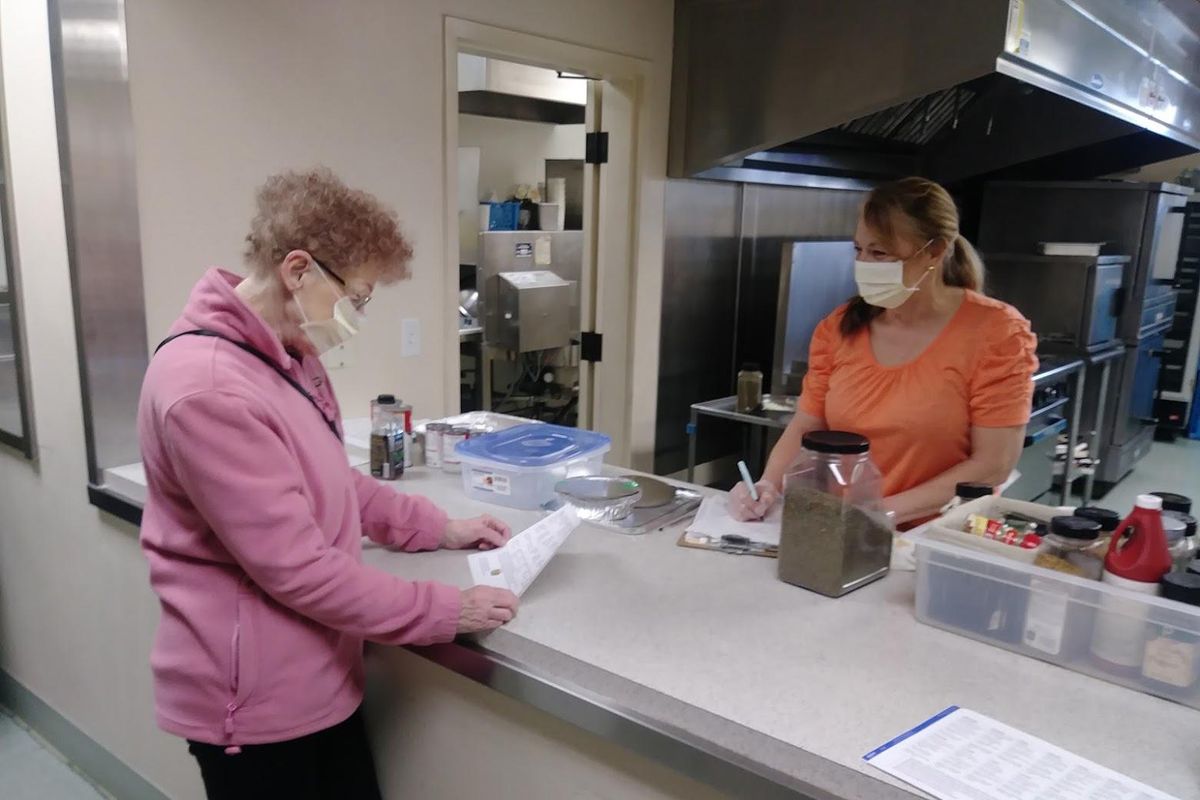 Kerry Edwards, right, takes an order from Southside Community Center regular Lois Bradshaw. Bradshaw has ordered several meals from Helpful Plates. (Courtesy / Southside Community Center)