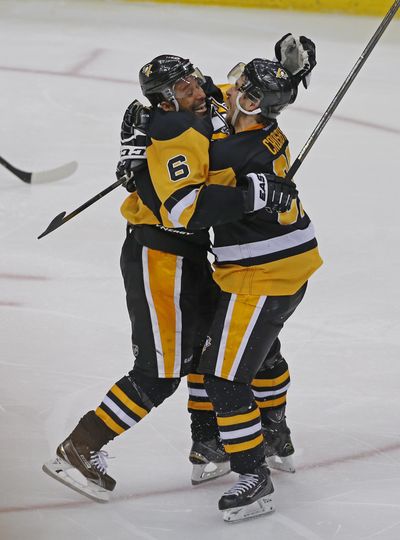 Pittsburgh Penguins’ Trevor Daley, left, and teammate Sidney Crosby celebrate the winning goal against the Washington Capitals. (Gene J. Puskar / Associated Press)
