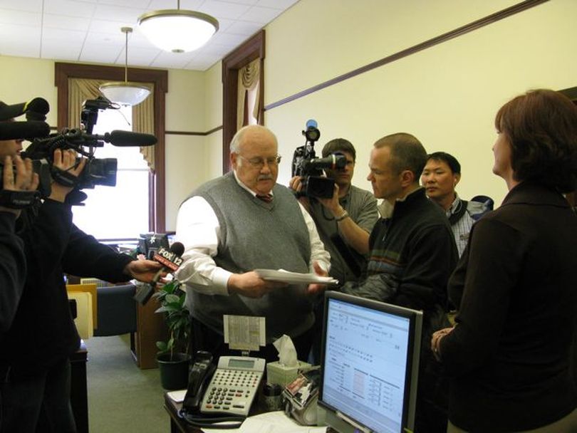 Secretary of State Ben Ysursa, center, accepts petitions Friday from Mike Lanza, center right, to launch a referendum drive to overturn SB 1184, the third school-reform bill; paperwork already has been approved to attempt a challenge to the two earlier school reform bills in the same manner. (Betsy Russell)