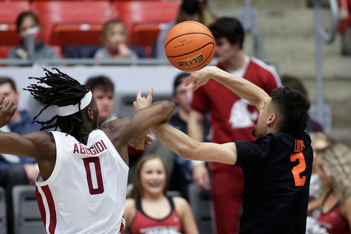 Washington State post Efe Abogidi, left, blocks a shot by Oregon State guard Jarod Lucas during the second half of a Pac-12 game on Thursday at Beasley Coliseum in Pullman.  (Associated Press)