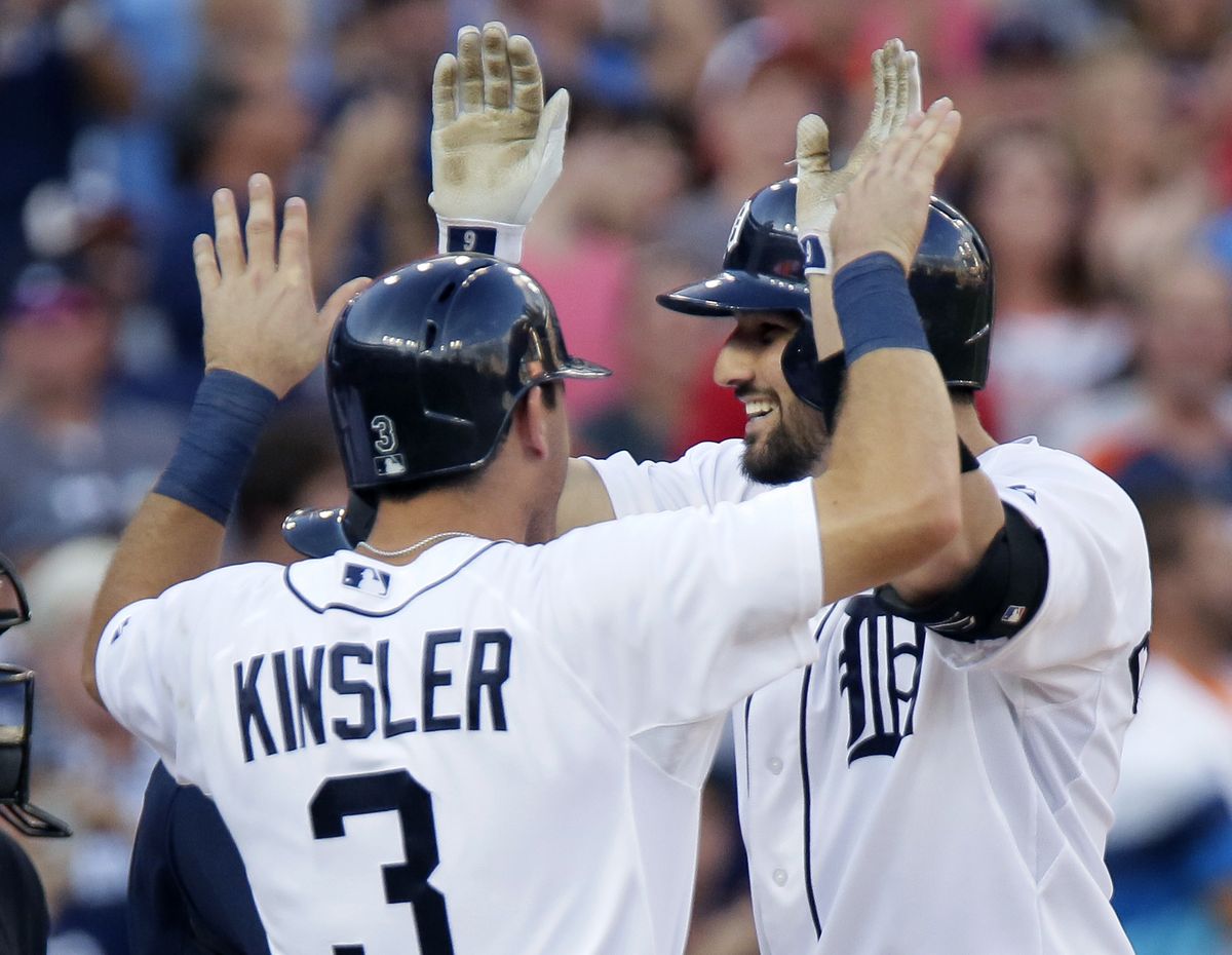 Tigers' Nick Castellanos, right, celebrates his third-inning grand slam with teammate Ian Kinsler on Wednesday. (Associated Press)