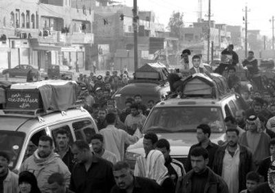 
Mourners follow a funeral procession carrying coffins of victims of Sunday's suicide car bomb through Baghdad's Shiite enclave of Sadr City on Monday. 
 (Associated Press / The Spokesman-Review)