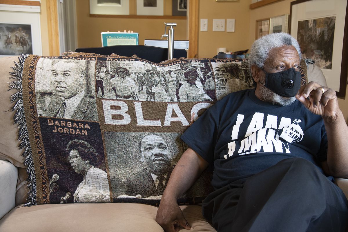 Artist Bob Lloyd sits in his Spokane living room on July 16. Lloyd recently completed painting in the “L” in the Black Lives Matter mural in downtown Spokane.  (Jesse Tinsley/The Spokesman-Review)