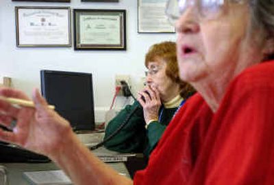 
Connie Carrigan, left, talks on the phone while volunteer Sue Havlovick deals with a person at the counter of COPS Northwest Thursday. With pending cuts in the police budget, both of them stressed the importance for the public to volunteer at the neighborhood COPS and to organize  neighbors for self-protection. 
 (Christopher Anderson/ / The Spokesman-Review)