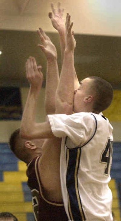 
Mead's Brendan Ingebitsen, right, runs into the elbow of University's Nate Thompson on Tuesday night. 
 (Brian Plonka / The Spokesman-Review)
