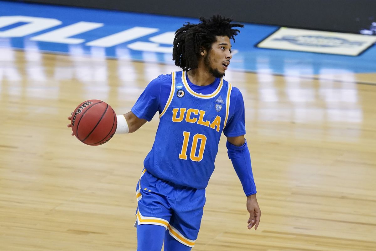 UCLA guard Tyger Campbell drives up court during the second half of an Elite 8 game against Michigan in the NCAA men's college basketball tournament at Lucas Oil Stadium, Tuesday, March 30, 2021, in Indianapolis.  (Darron Cummings)