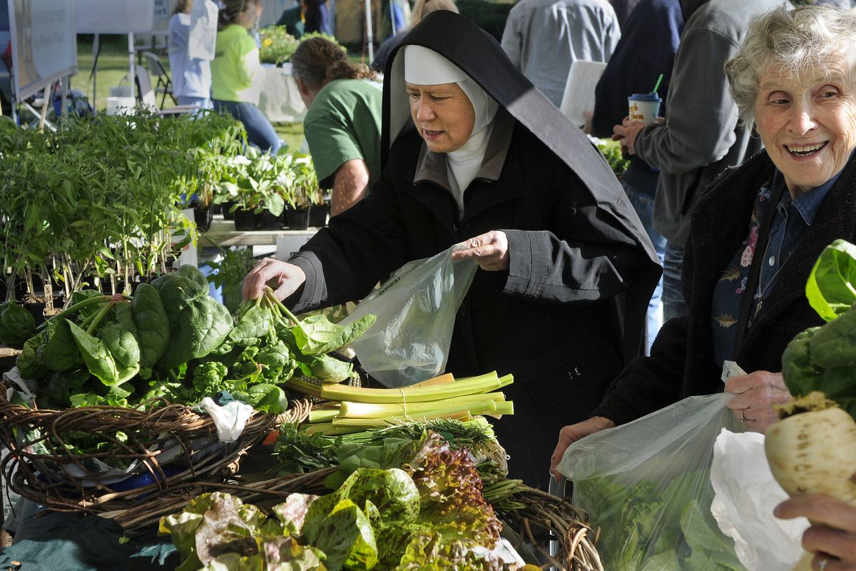 Sister Mary Laboure and her mother, Donna Mae Berube, search for fresh vegetables Saturday at the Spokane Farmers Market. (Dan Pelle)