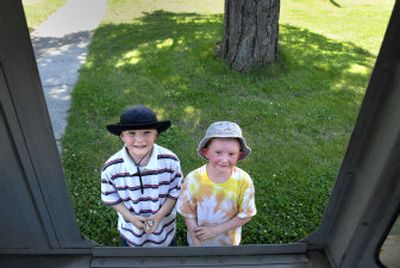 
Benjamin, 8, and Gabriel Bagley, 6, wait for treats, Aug. 1,  along a South Hill street after waving down the ice cream truck. 
 (Brian Plonka / The Spokesman-Review)