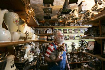 
Paul Wellborn, holding his dog Honeybug, tours a small portion of his collection of electric toasters and other antiques in Springfield, Ore. The 77-year-old started collecting when he was a child. 
 (Associated Press / The Spokesman-Review)