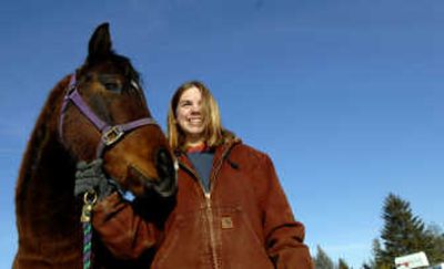 
Sarah Pennington, 17, of Spirit Lake stands with her new horse, Bomber, which was given to her after her mare died. 
 (Kathy Plonka / The Spokesman-Review)