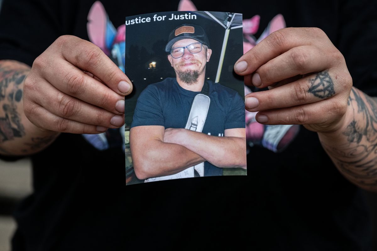Heather LaBrie holds a photo of her brother, Justin LaBrie, who died Monday at the hospital after he was hit April 27 by an alleged hit-and-run driver while walking home in north Spokane. Police are trying to identify the driver. (COLIN MULVANY /THE SPOKESMAN-REVIEW)