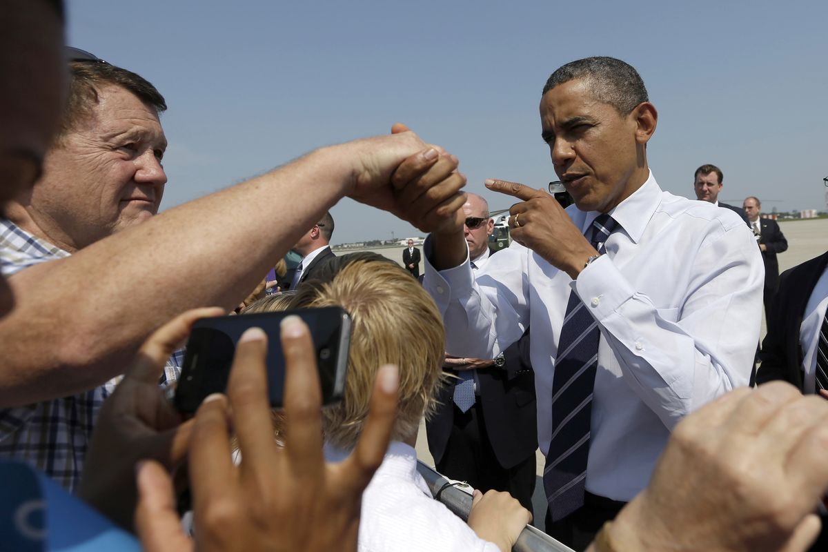 President Barack Obama greets supporters on the tarmac upon his arrival at Des Moines International Airport in Des Moines, Iowa, Tuesday, Aug. 28, 2012. (Pablo Monsivais / Associated Press)