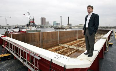 Ed Whitmore of Norfolk Tug Co. stands atop a barge at  the company’s dock in Norfolk, Va.,  in December  2008. Whitmore is intent on reducing truck traffic on Virginia’s Interstate 64 by sending goods by barge up the James River to the Port of Richmond.  (Associated Press / The Spokesman-Review)
