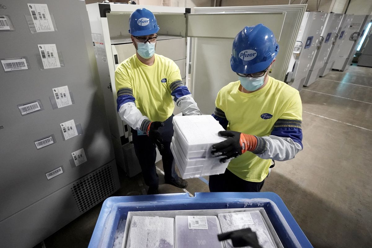 FILE - Boxes containing the Pfizer COVID-19 vaccine are prepared to be shipped at the Pfizer Global Supply Kalamazoo manufacturing plant in Portage, Mich., Dec. 13, 2020. The nation’s COVID-19 death toll stands at around 800,000 as the anniversary of the U.S. vaccine rollout arrives. A year ago it stood at 300,000. What might have been a time to celebrate a scientific achievement is fraught with discord and mourning.  (Morry Gash)