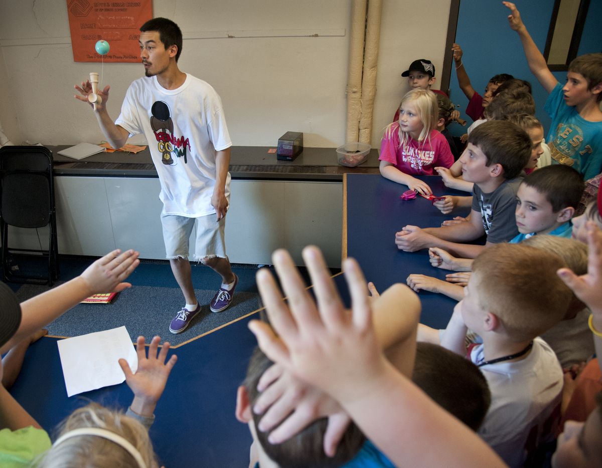Daniel Robinson exhibits his kendama skills to children at the Boys and Girls Club on Aug. 9, in Mead. (Dan Pelle)