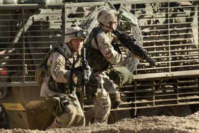 
U.S. Army 1st Battalion, 24th Infantry soldiers run for cover Wednesday during a gunbattle with insurgents in Mosul, Iraq. 
 (Associated Press / The Spokesman-Review)