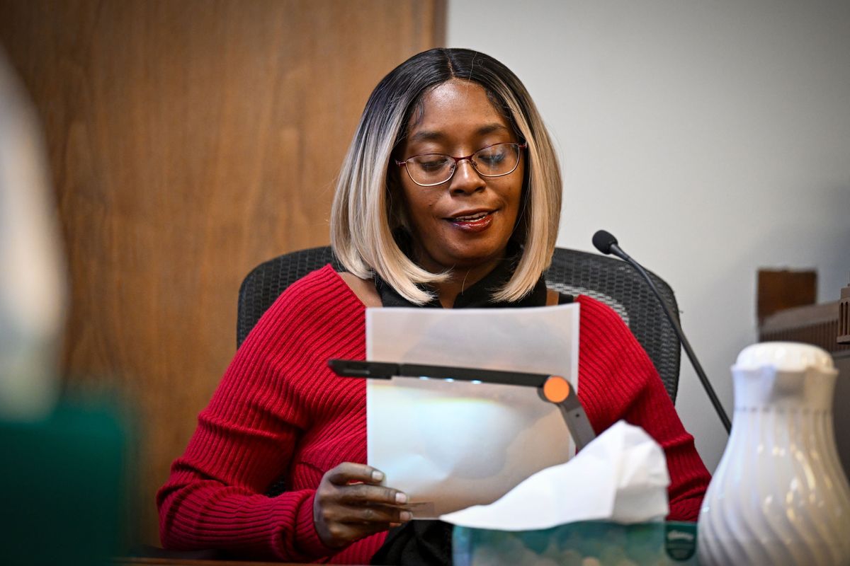 While on the witness stand, Laquisa Doss holds a picture of her mother, Ruby Doss, on Wednesday at the Spokane County Courthouse.  (DAN PELLE/THE SPOKESMAN-REVIEW)