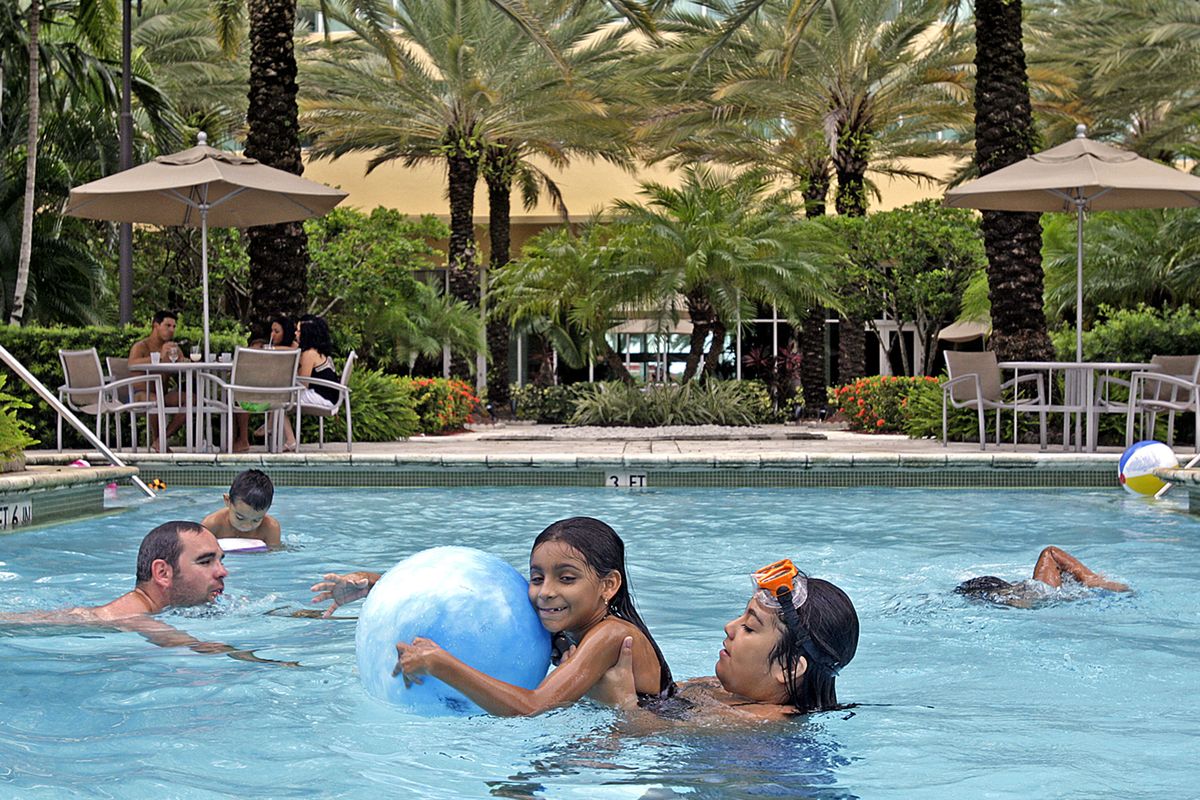 Daniela Araya, 7, and her cousin Genesis Araya, 11, swim at the InterContinental Hotel West in Doral, Fla. McClatchy photos (McClatchy photos / The Spokesman-Review)