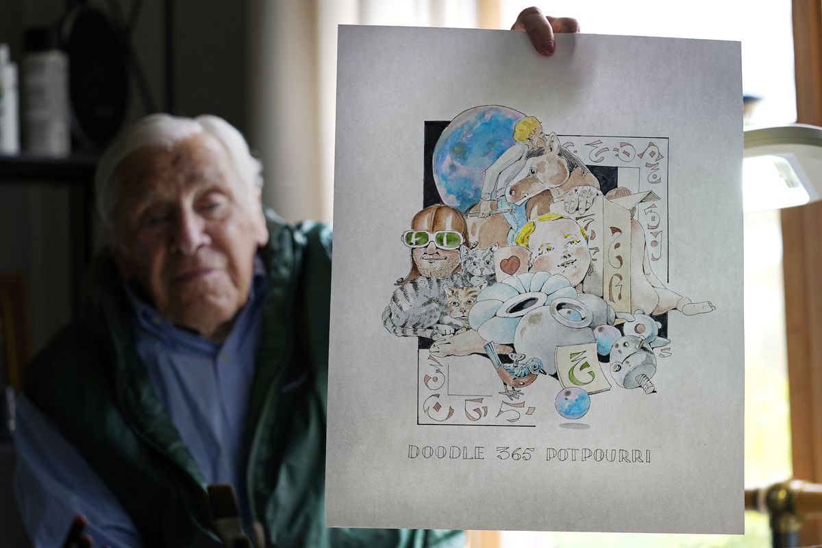 Artist Robert Seaman holds up the 365th daily doodle sketch in his room at an assisted living facility Monday in Westmoreland, N.H.  (Charles Krupa)