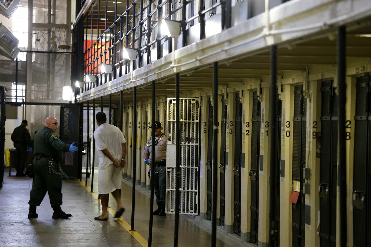 FILE - In this Aug. 16, 2016, file photo a condemned inmate is led out of his east block cell on death row at San Quentin State Prison, in San Quentin, Calif. California Gov. Gavin Newsom is moving to dismantle the nation