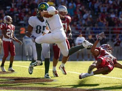
With a hop, skip and a jump, Oregon quarterback Kellen Clemens dodges the last Washington State defender and scores one of his three touchdowns. 
 (Christopher Anderson/ / The Spokesman-Review)