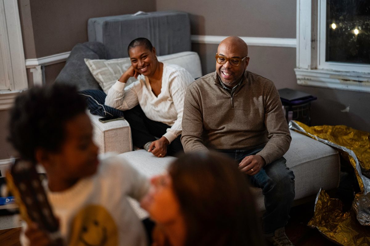 Marc Easton and his wife, Cristina Easton, watch as their son Ellis works with Corinne Zmoos, a speech therapist from Crescendo Communication. Ellis is a nonspeaking kindergartner who communicates through music. (Salwan Georges/Washington Post)