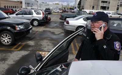 Spokane police Officer Tim Moses  spends more time patrolling  downtown Spokane parking lots after vehicle prowlings  increased to more than 100 per week in the past few months.  (Dan Pelle / The Spokesman-Review)